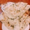 Soft unleavened bread stuffed with cheese and garlic cooked in tandoor.
