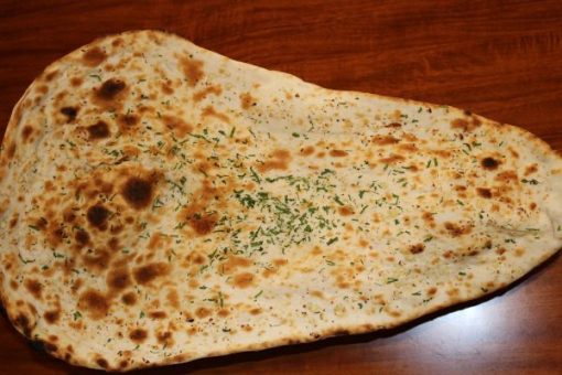 Garlic naan oven(tandoor) backed flat bread topping with butter and garlic